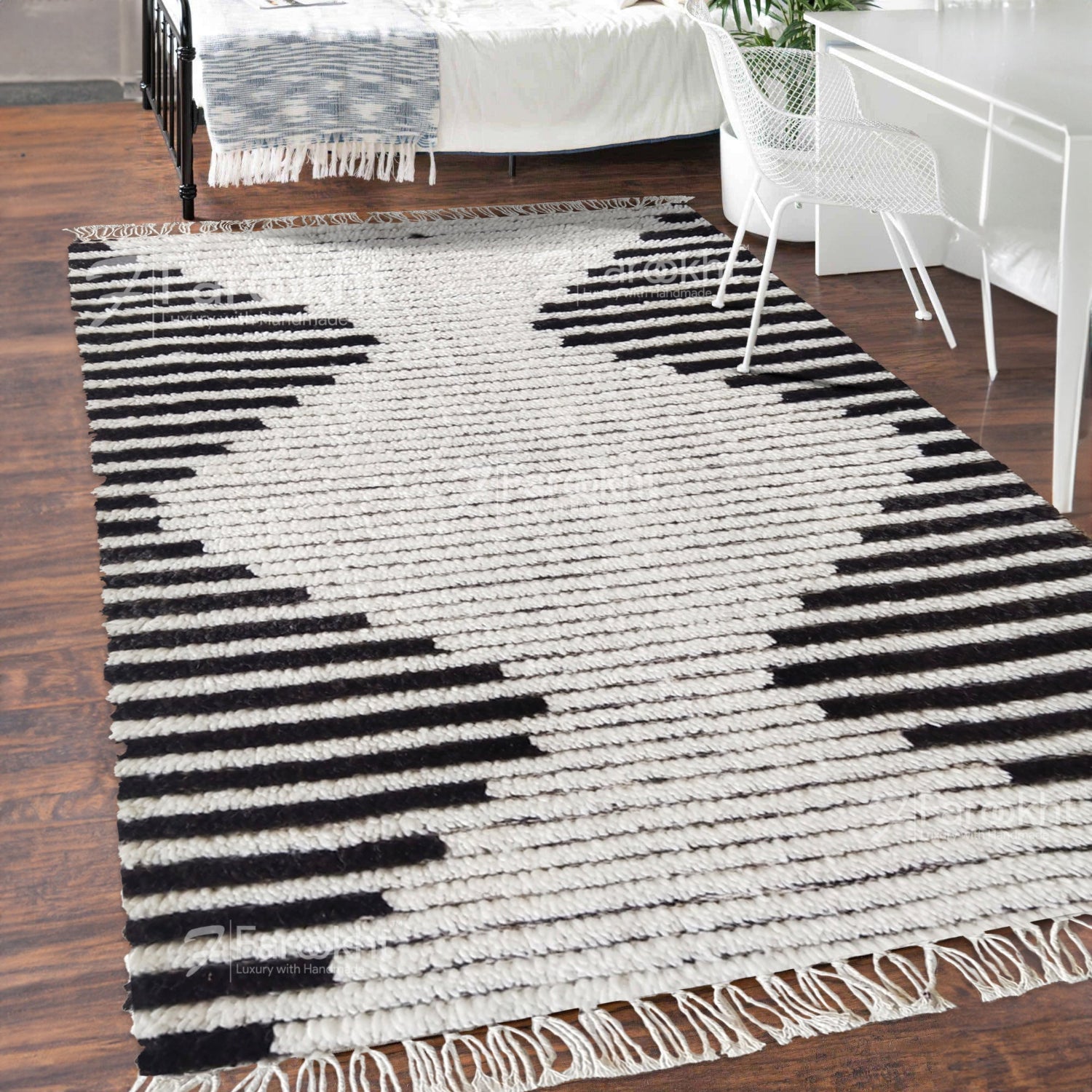 Black and white striped rug on a wooden floor with furniture in the background
