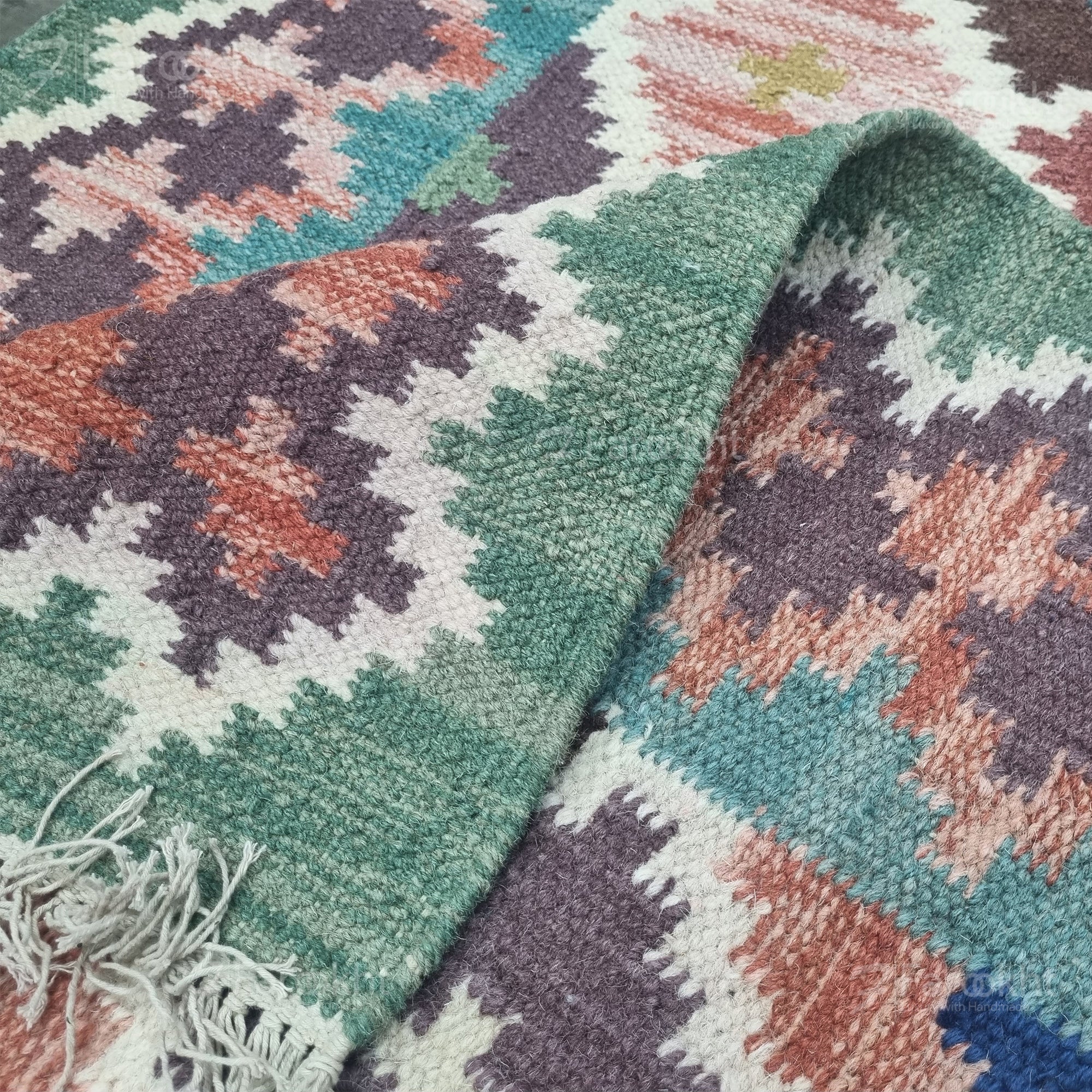 Close-up of a colorful patterned rug with geometric design.