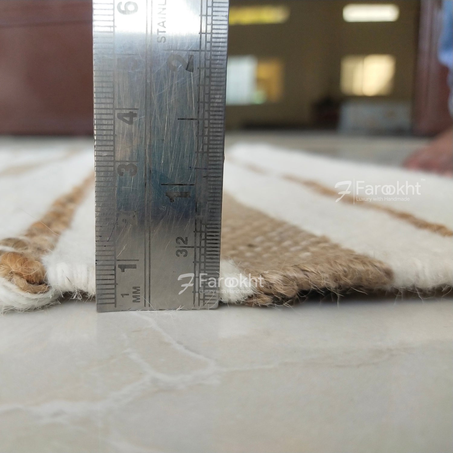 Rug with a ruler for scale on a blurred indoor background
