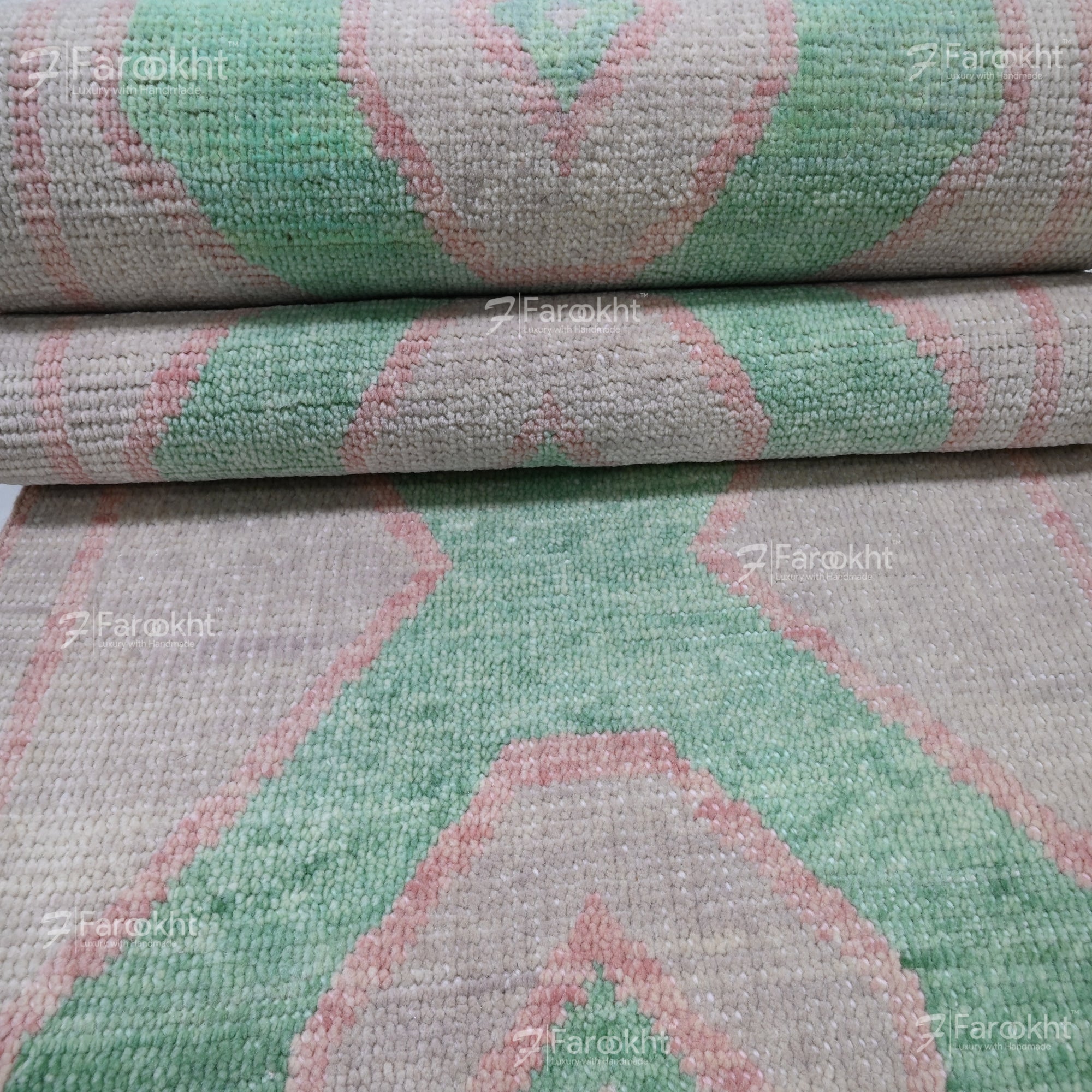 Close-up of a textured fabric with green and pink geometric pattern