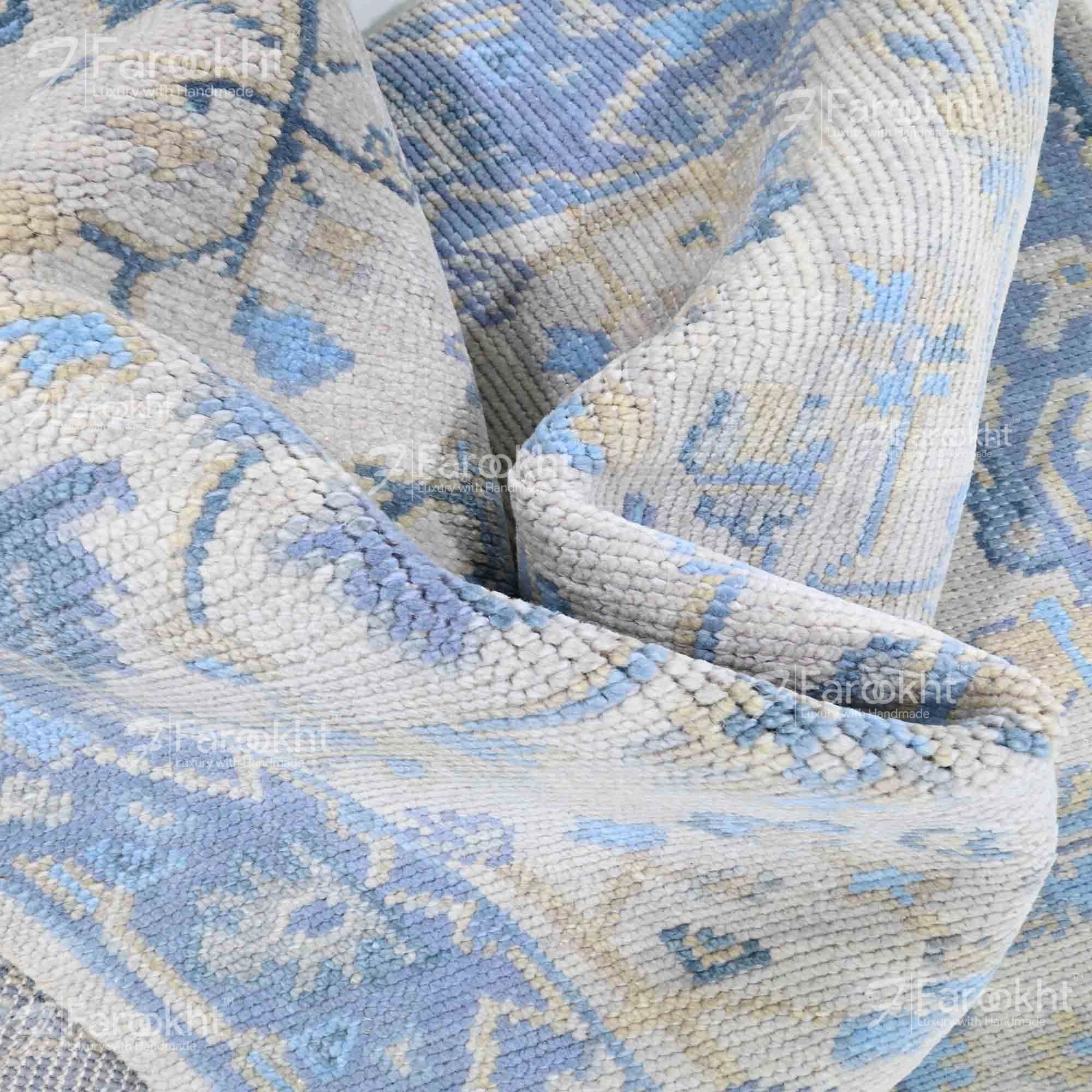 Close-up of a patterned blue and beige rug with &