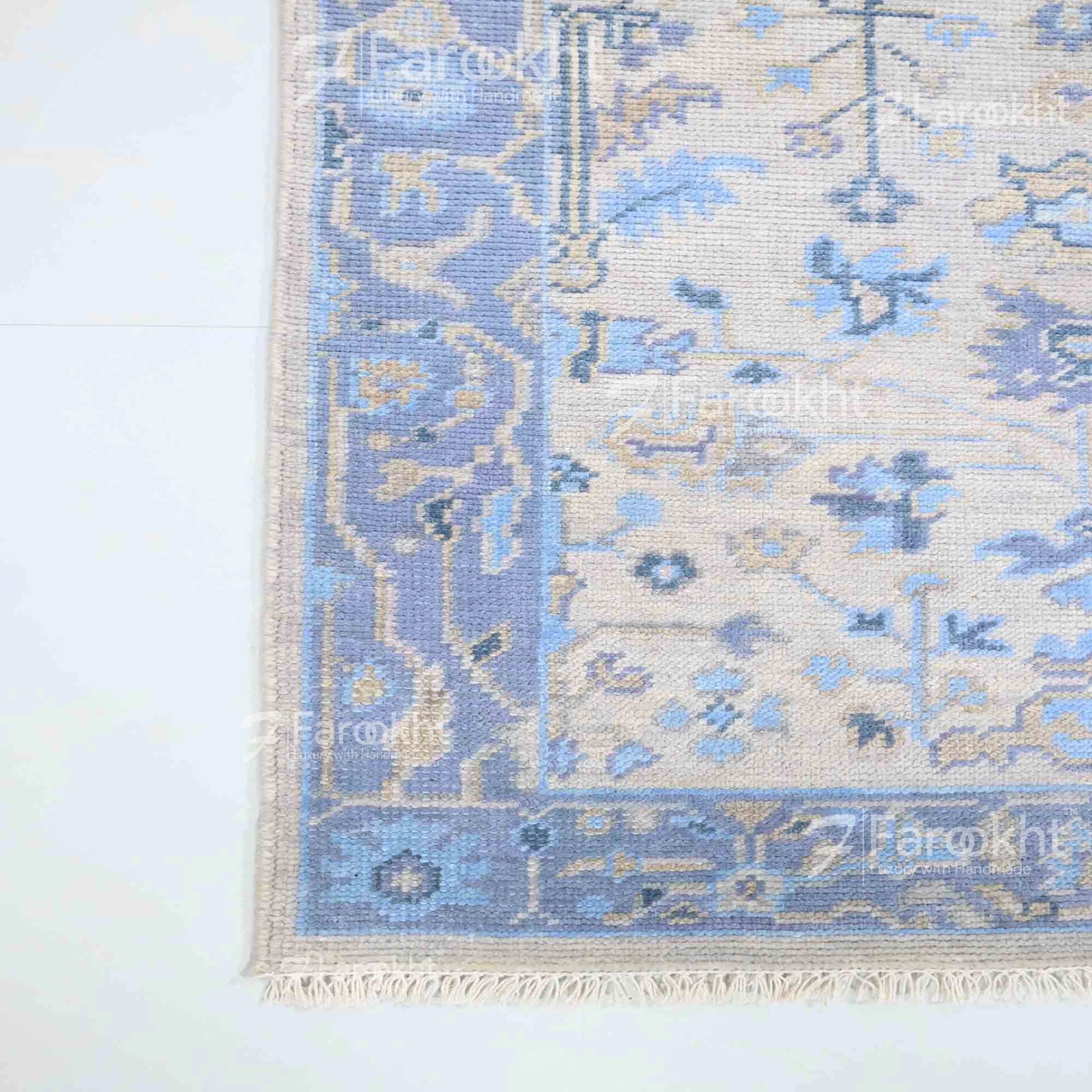 Blue and beige patterned rug on a white background
