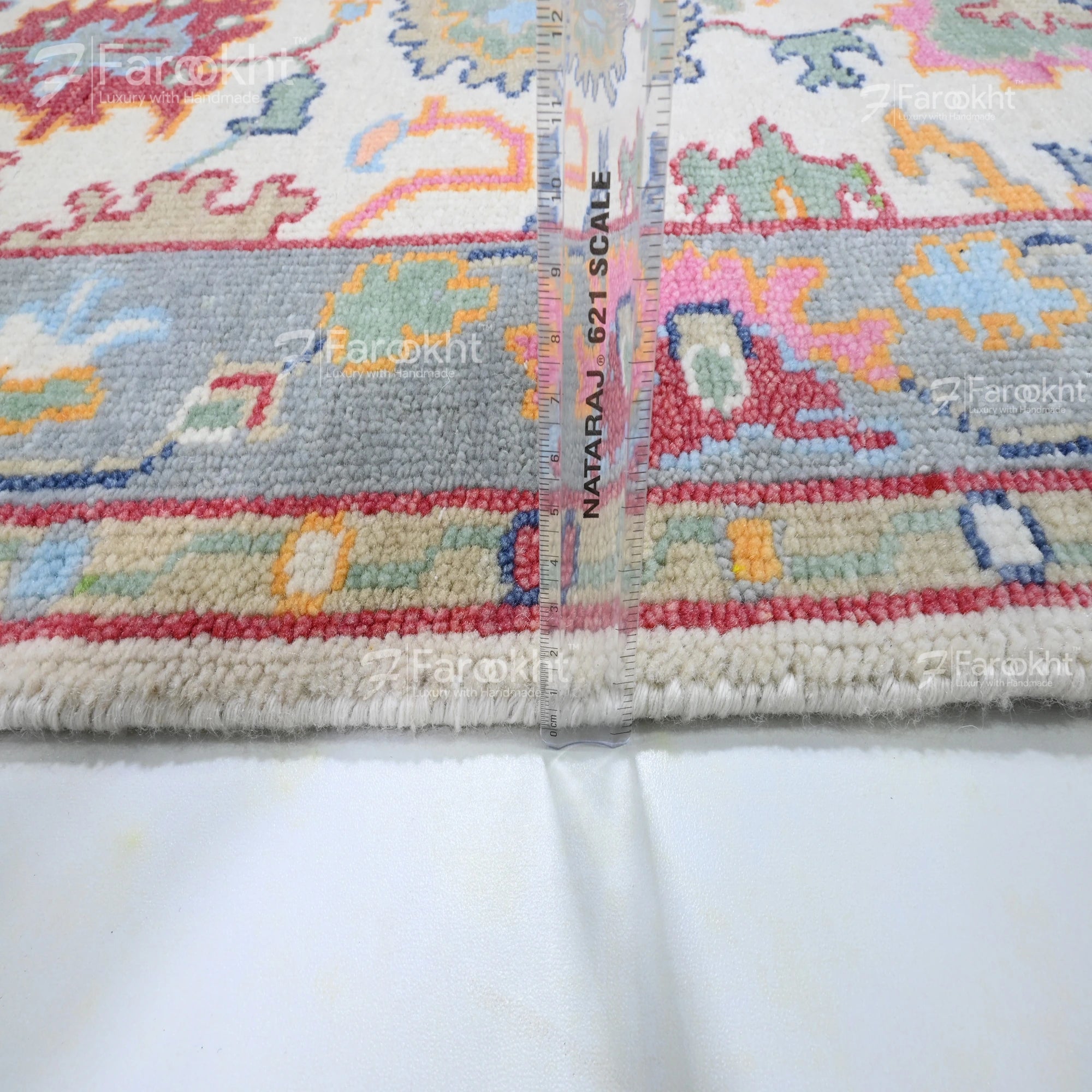 Close-up of a colorful patterned fabric with measurement scale on a white background