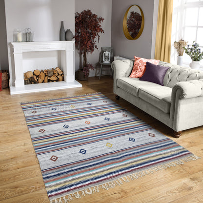 Living room with a colorful striped rug, gray sofa, and fireplace.