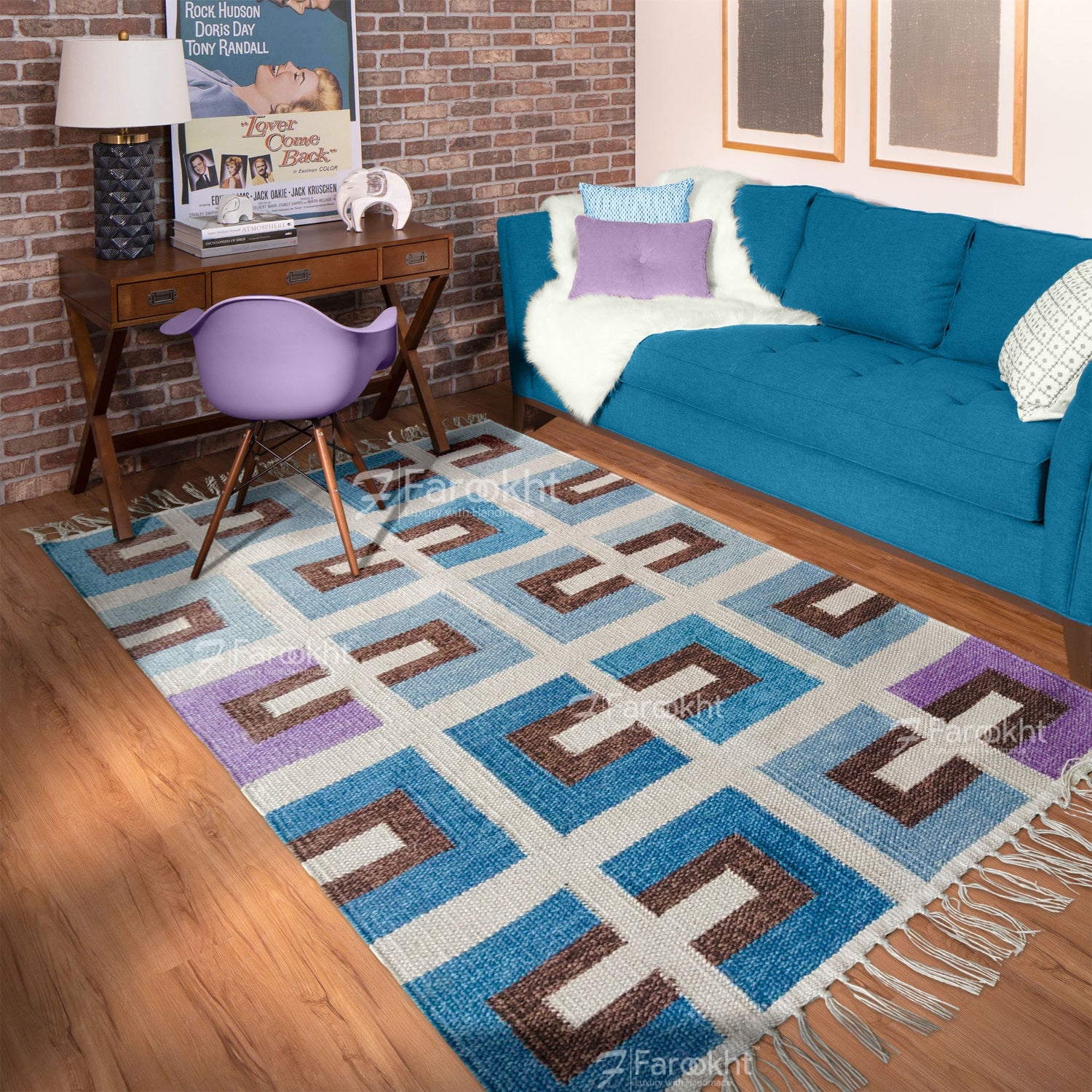 Living room with a geometric patterned rug, blue sofa, and purple chair.
