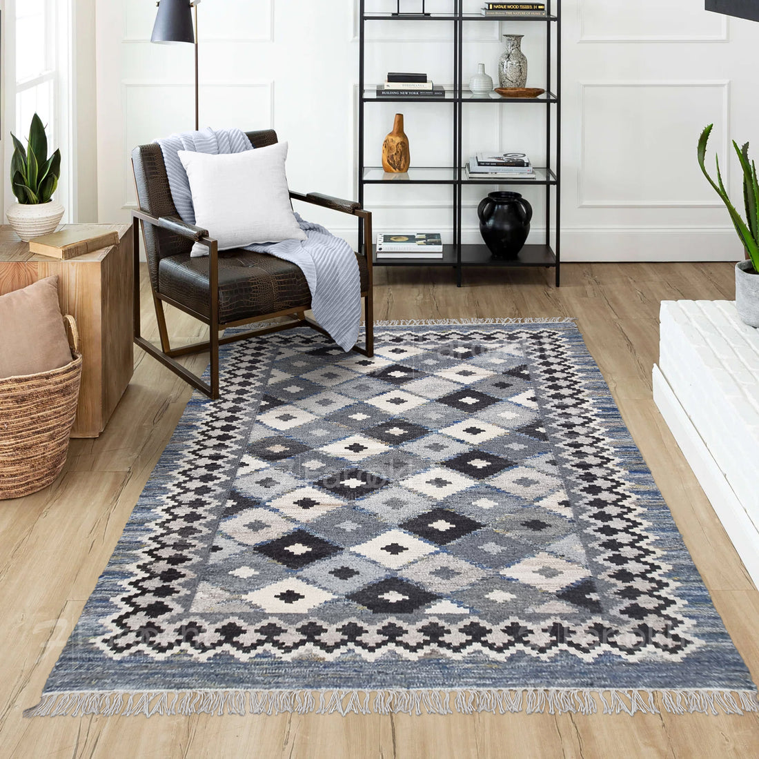 Patterned rug on a wooden floor with a chair and shelves in the background