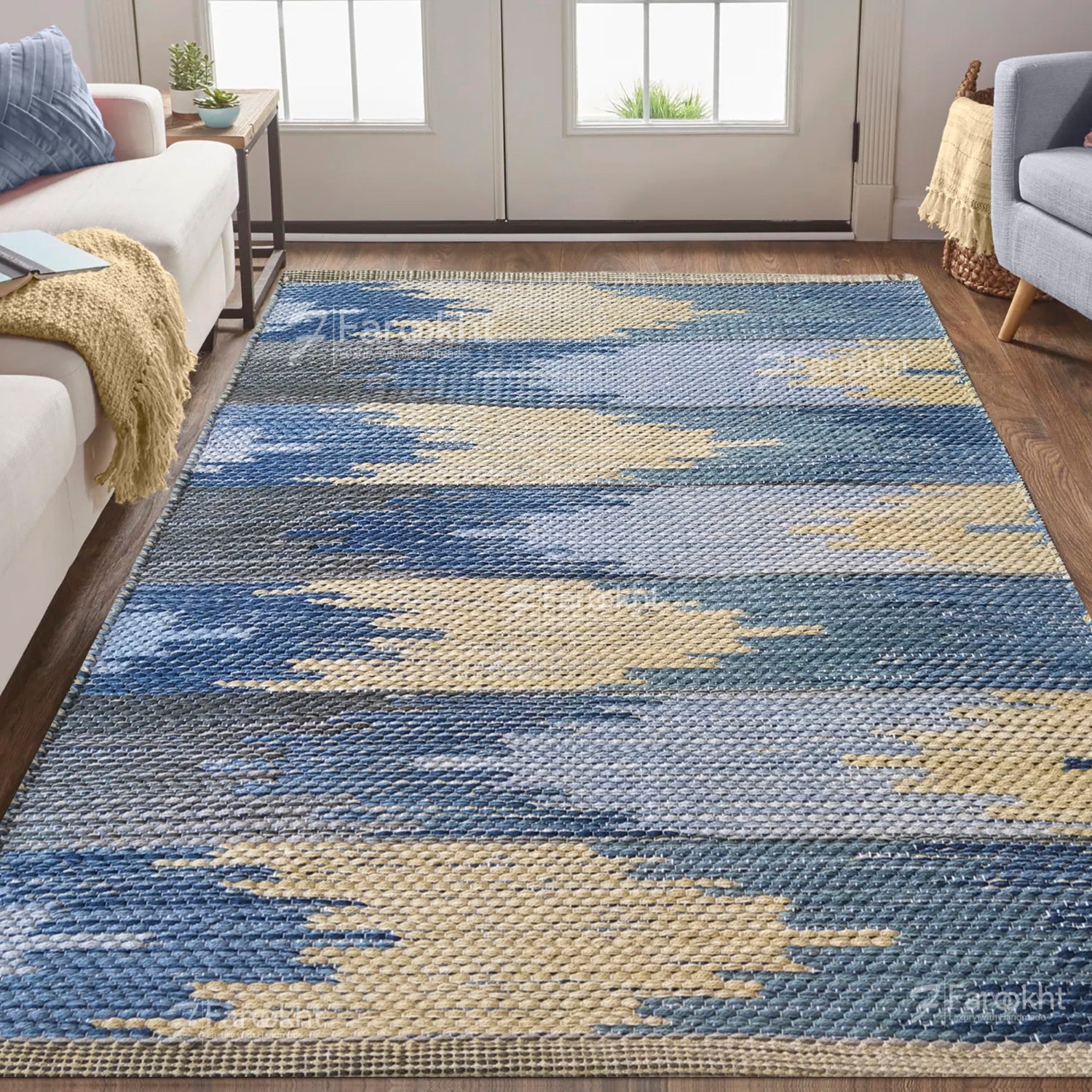 Blue and beige patterned rug in a living room setting with furniture.