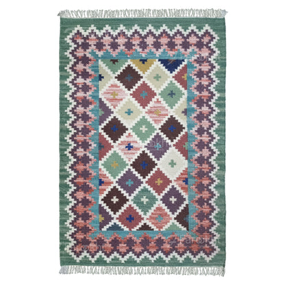 Multicolored geometric patterned rug with fringes on a white background