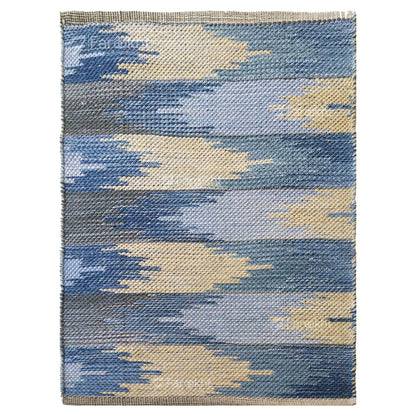 Rectangular rug with blue and beige geometric pattern on a white background