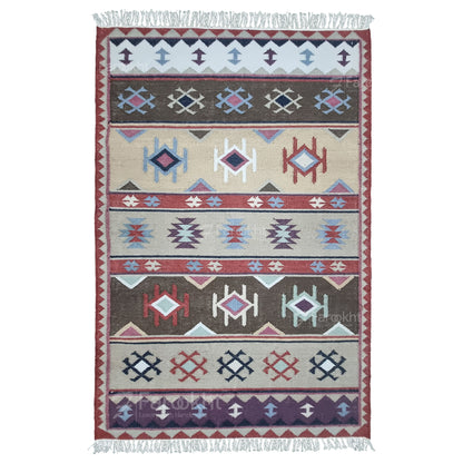 Handwoven rust beige geometric wool-blend rug with teal and purple accents, fringe edges and tribal pattern. Available in multiple sizes for all living spaces