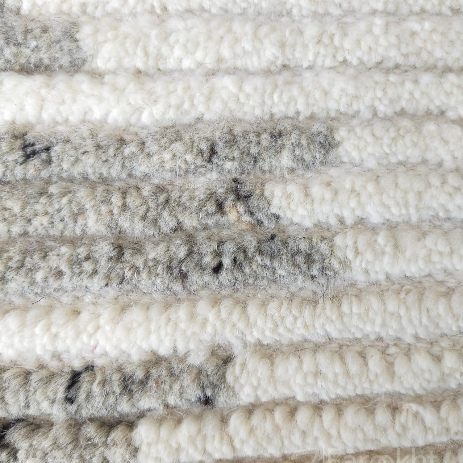 Close-up of textured white and gray carpet samples