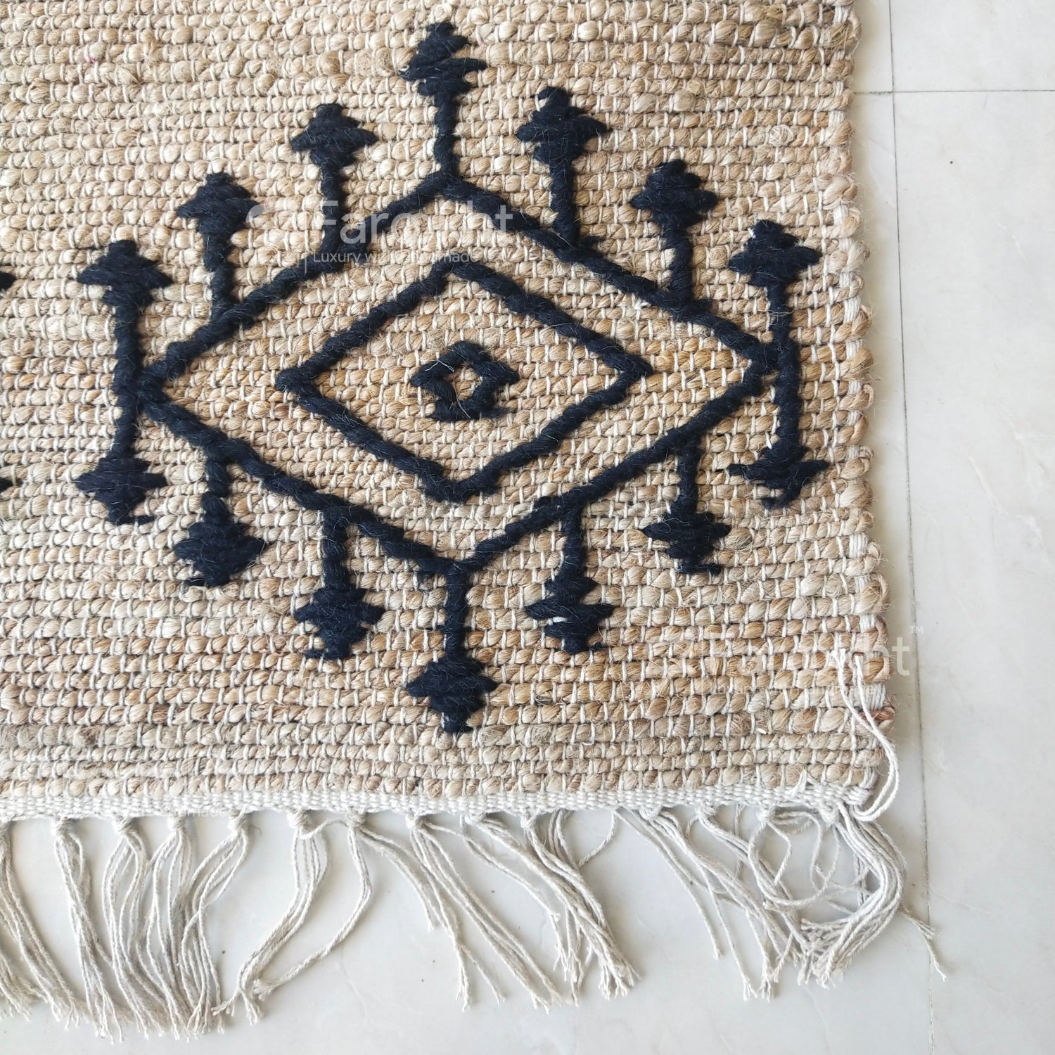 Textile with black geometric patterns on a beige background