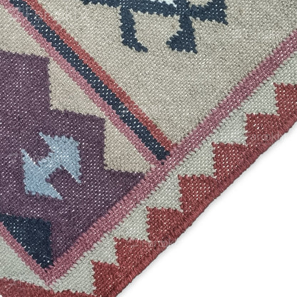 Handwoven Rust Beige Geometric wool-blend rug with teal and purple accents, fringe edges and tribal pattern. Available in multiple sizes for all living spaces