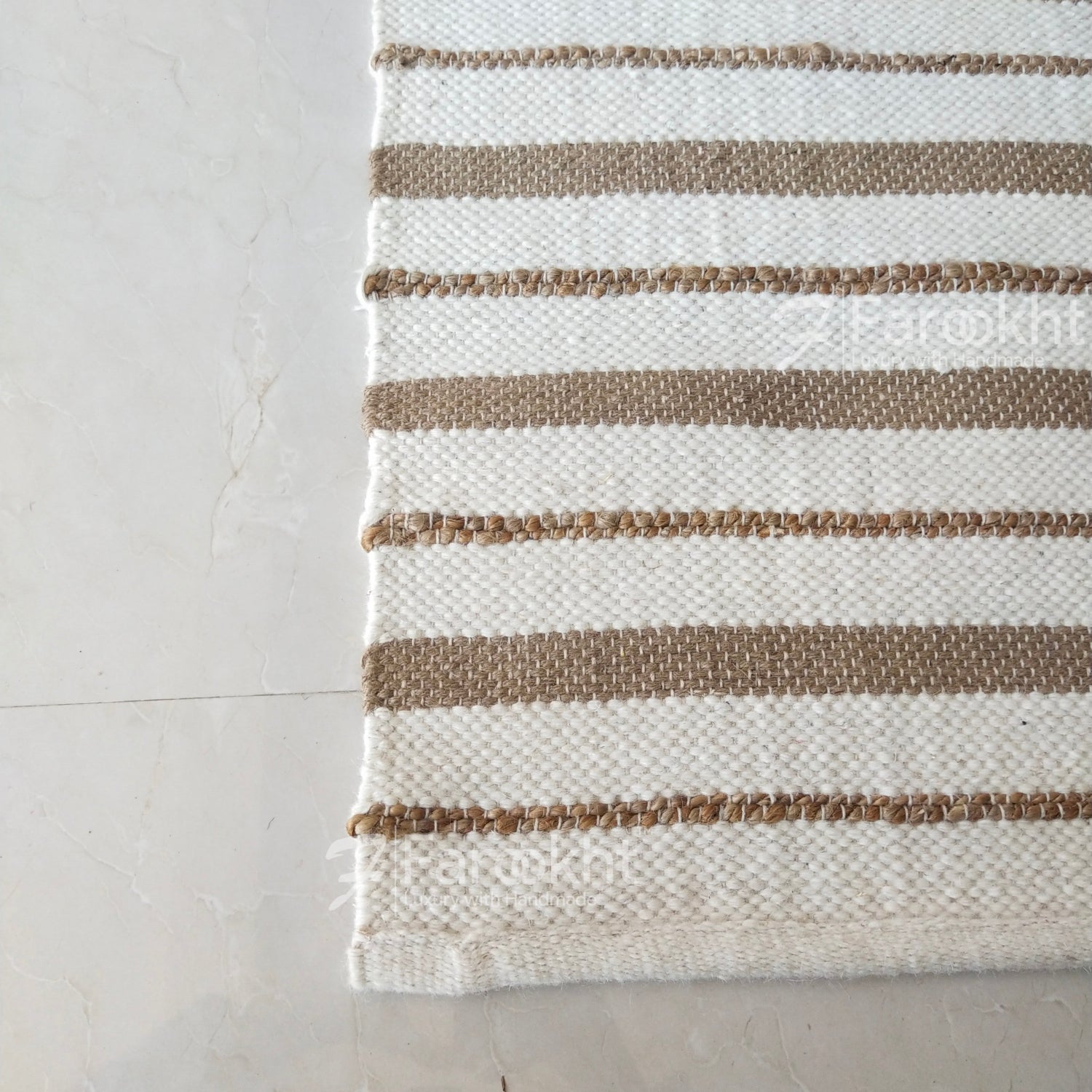 Striped rug with brown and beige stripes on a light gray floor