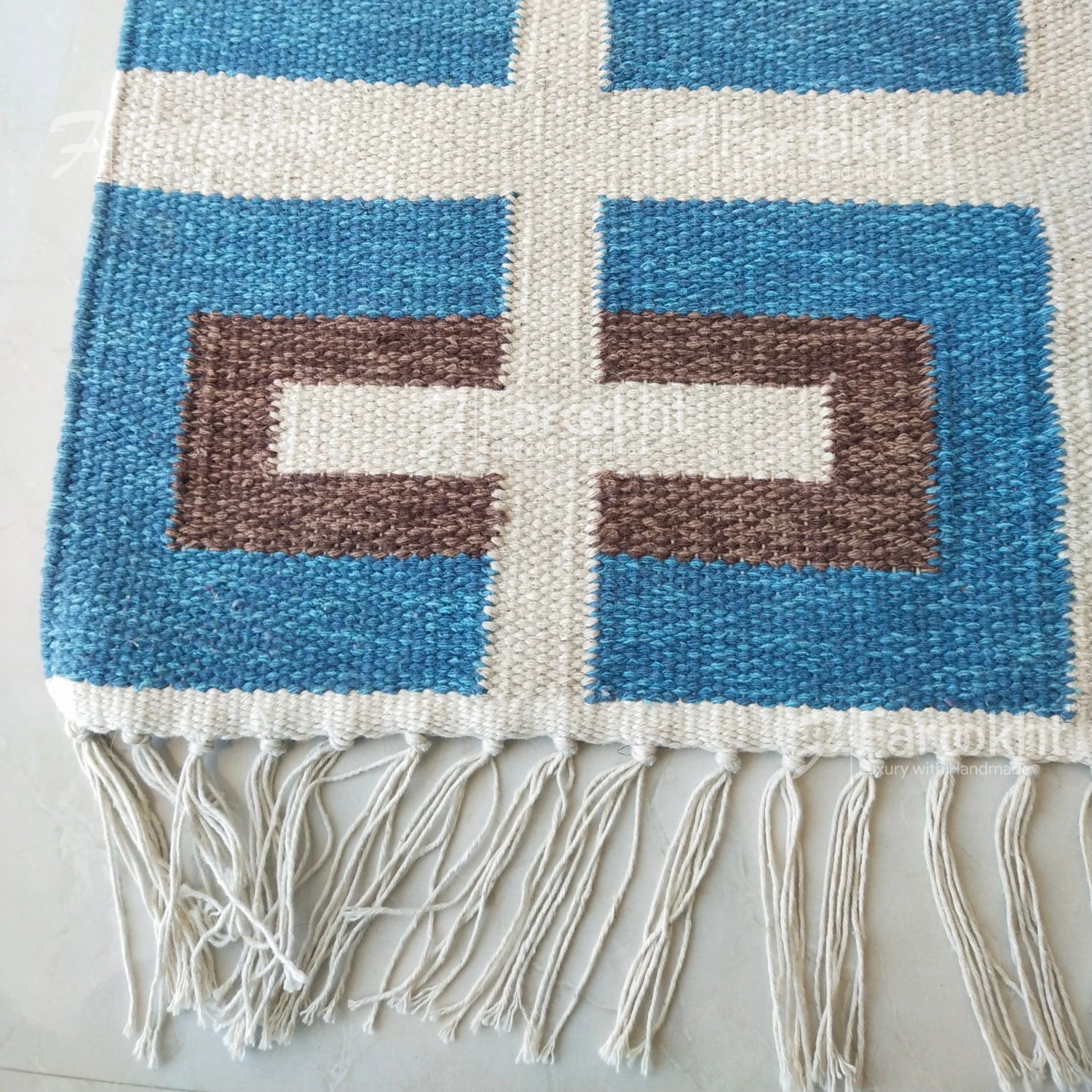 Woven blanket with geometric pattern on a light background
