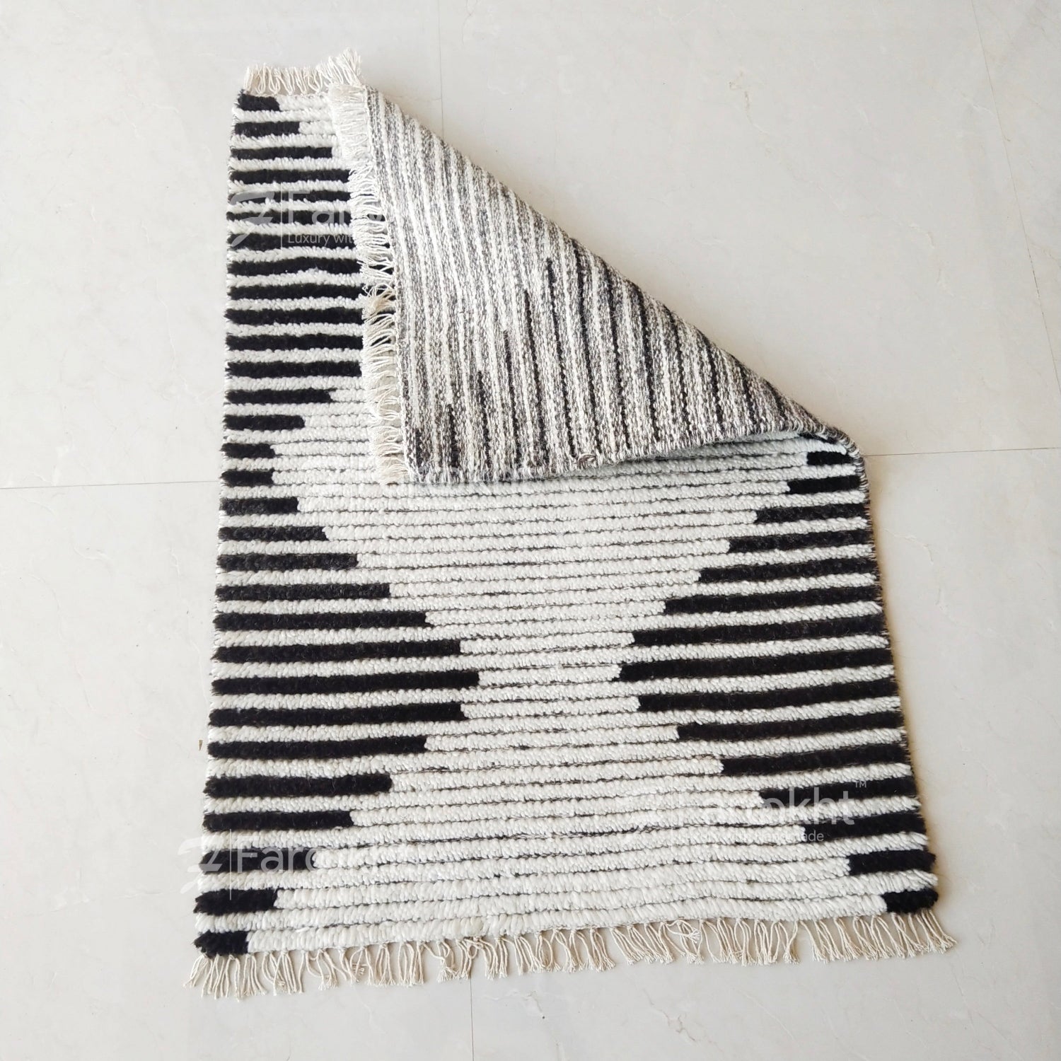 Textured rug with black and white pattern on a light gray background