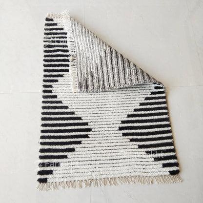 Textured rug with black and white pattern on a light gray background
