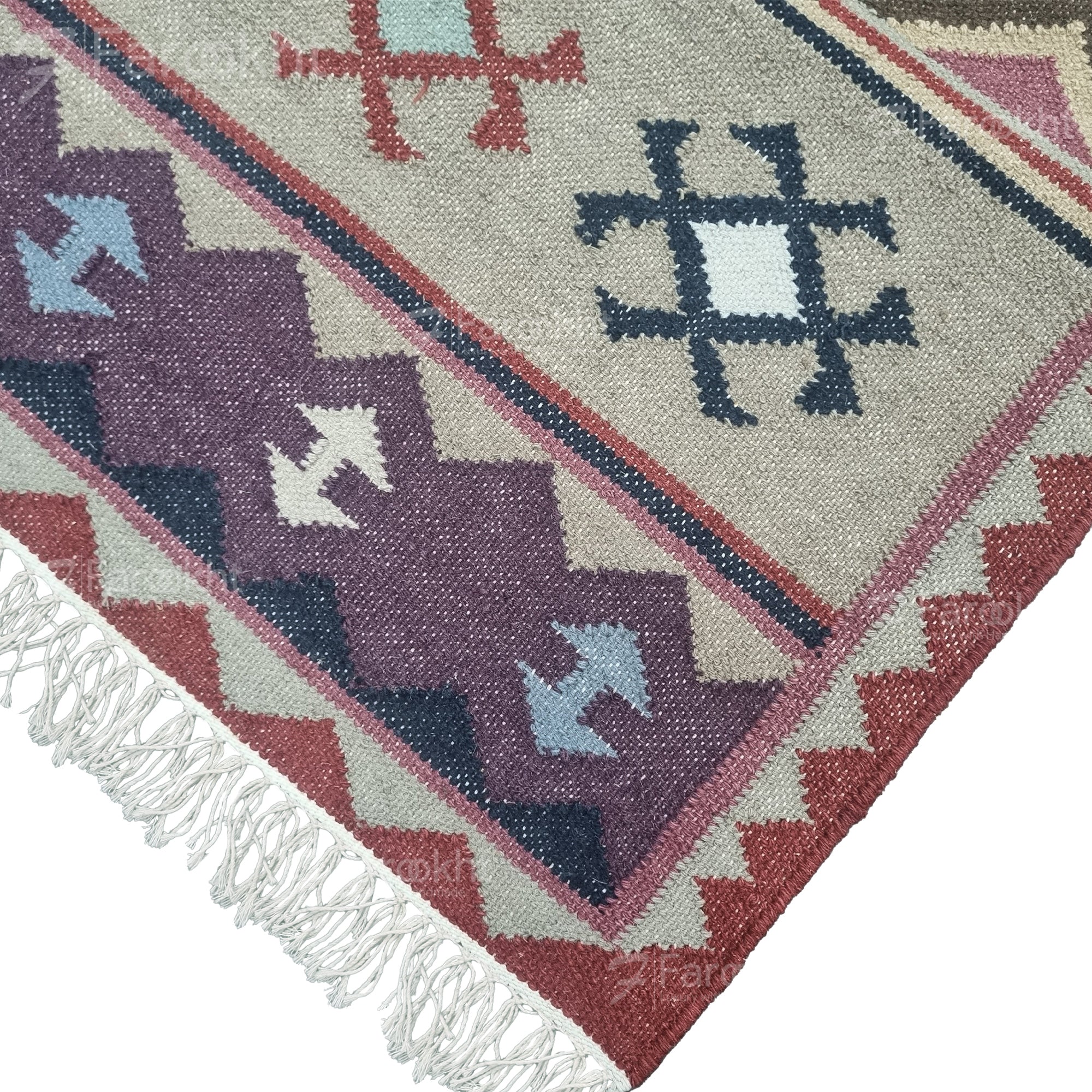 Handwoven rust beige geometric wool-blend rug with teal and purple accents, fringe edges and tribal pattern. Available in multiple sizes for all living spaces
