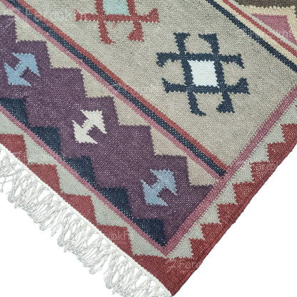 Handwoven rust beige geometric wool-blend rug with teal and purple accents, fringe edges and tribal pattern. Available in multiple sizes for all living spaces