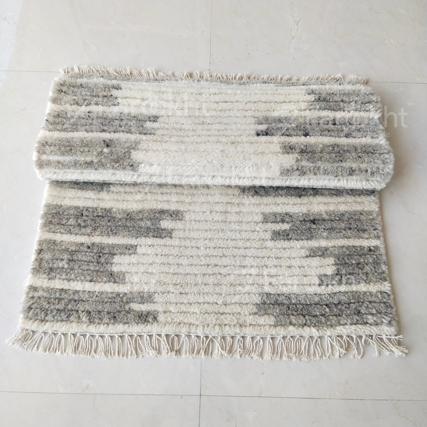 Textured area rug with geometric pattern on a light gray floor