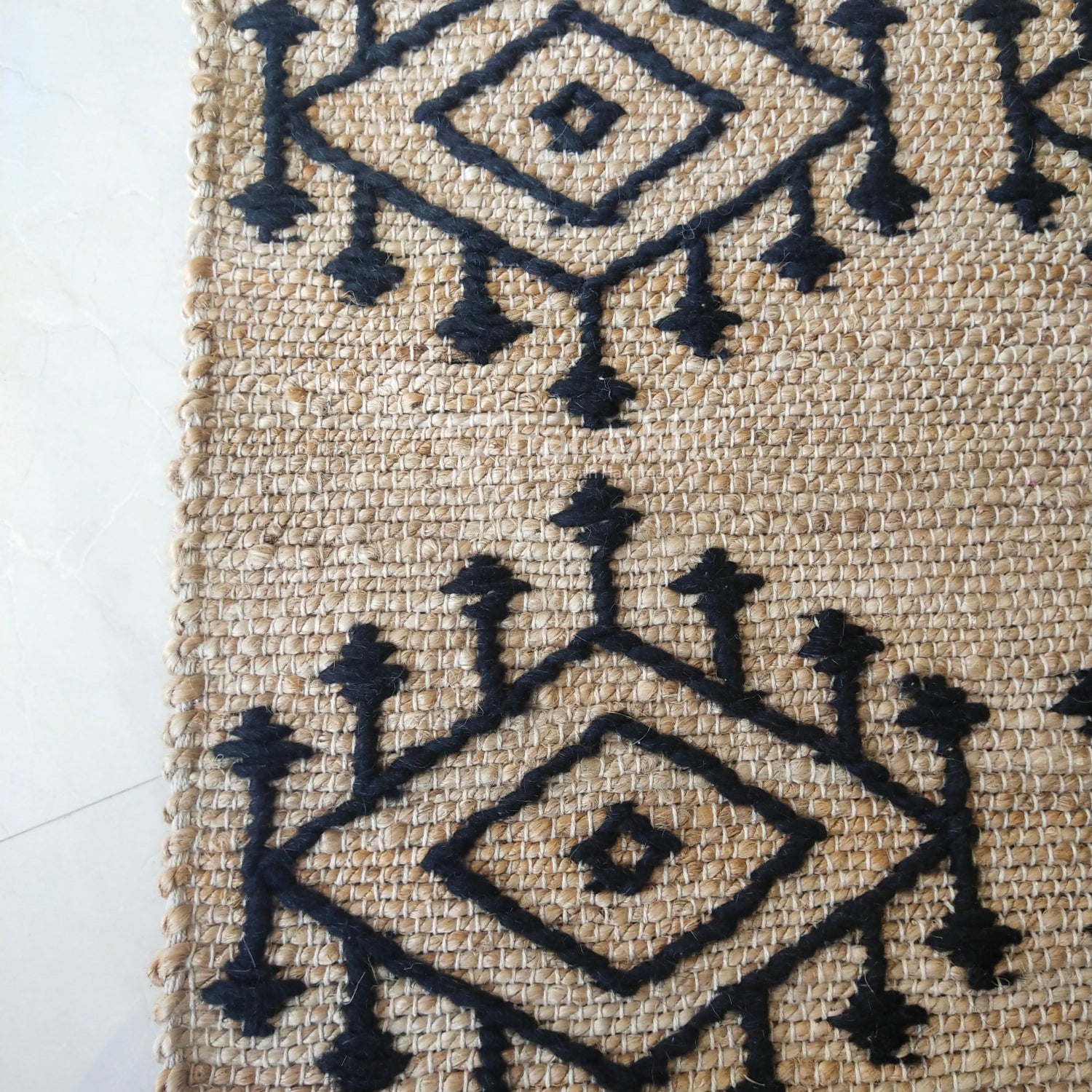 Textile with black geometric patterns on a beige background