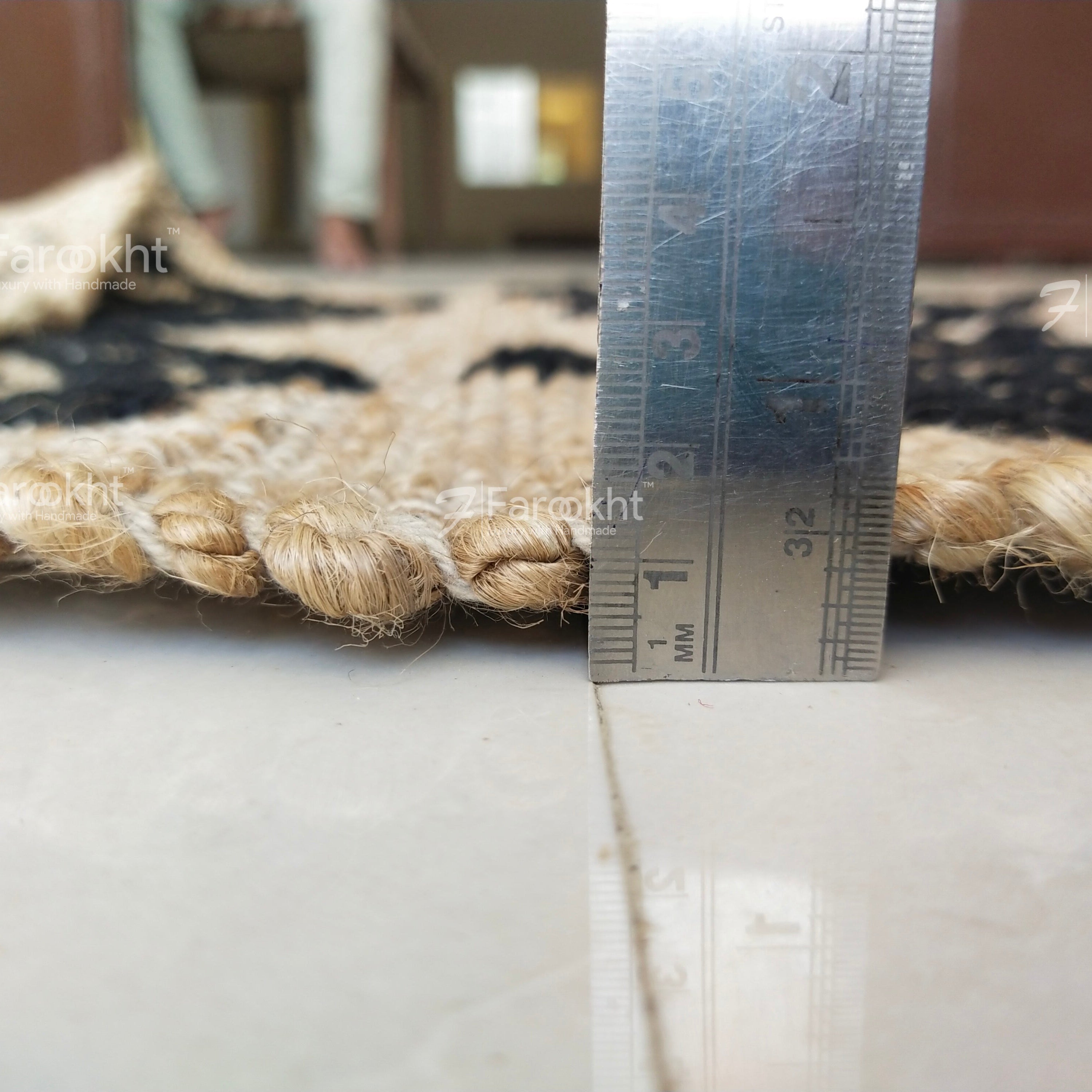 Rug with a metal ruler showing measurement details on a white surface