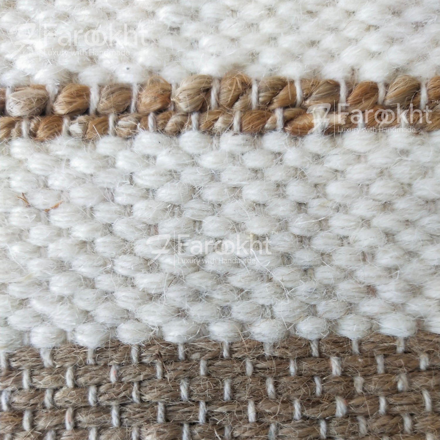 Close-up of a woven textile with white and brown patterns, branded &