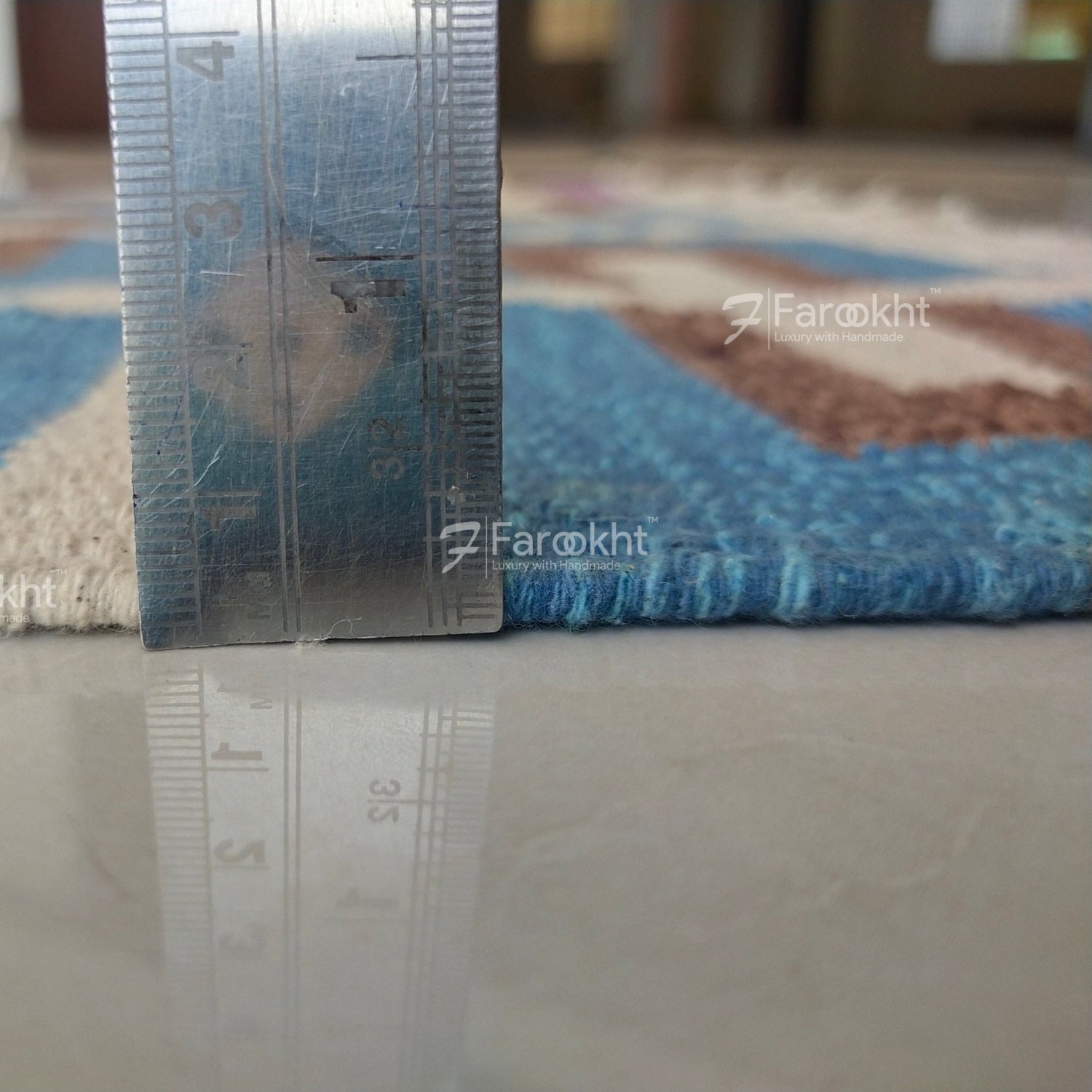 Metal ruler on a patterned rug with &