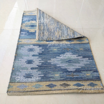 Blue patterned rug on a white floor