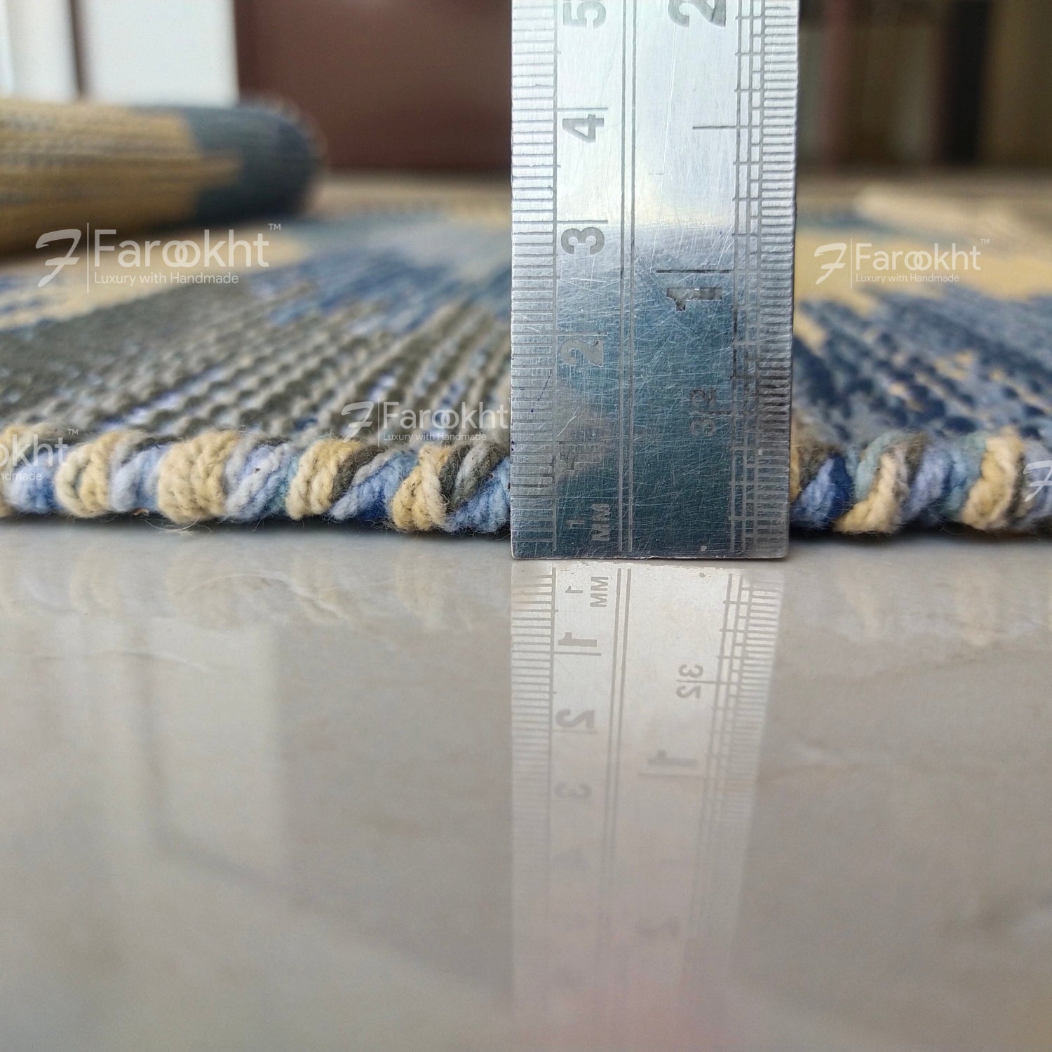 Rug with a ruler for scale on a neutral background