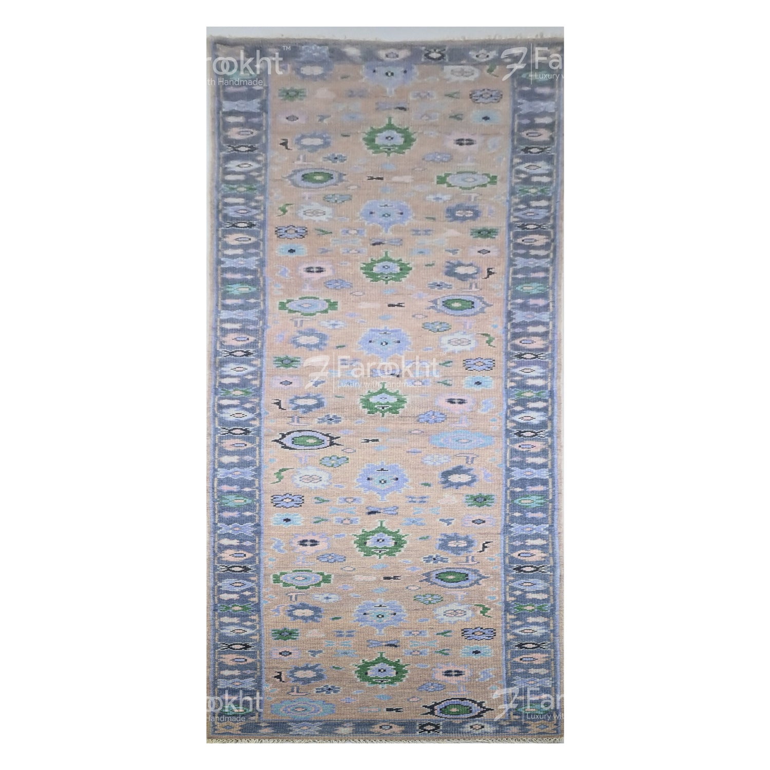 Decorative rug with floral patterns on a beige background, featuring the brand &