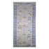 Decorative rug with floral patterns on a beige background, featuring the brand &