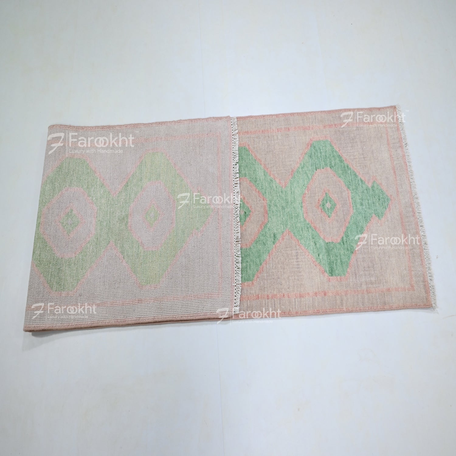 Woven mat with green geometric pattern on a white background, branded &