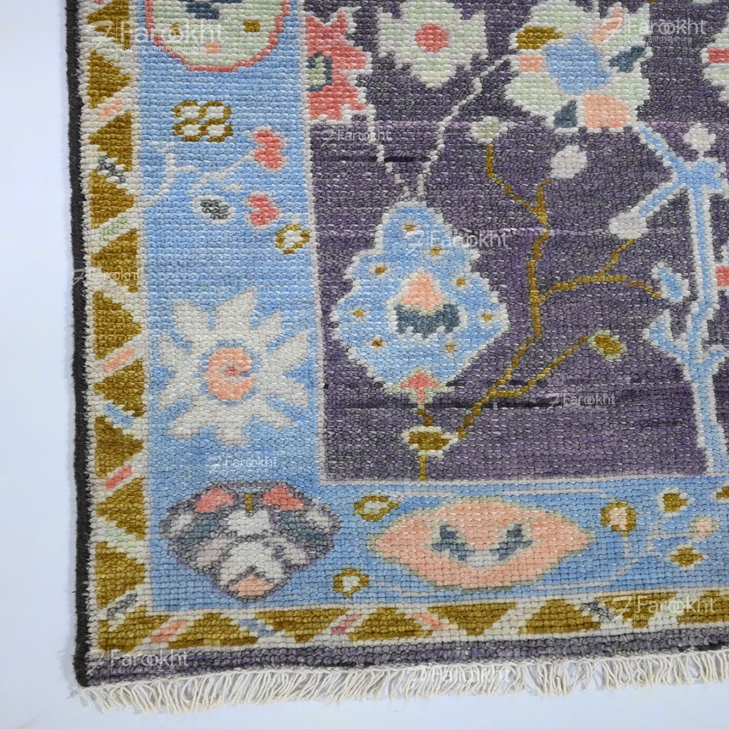Elegant wool blend hand-knotted rug featuring blue border and intricate floral motifs