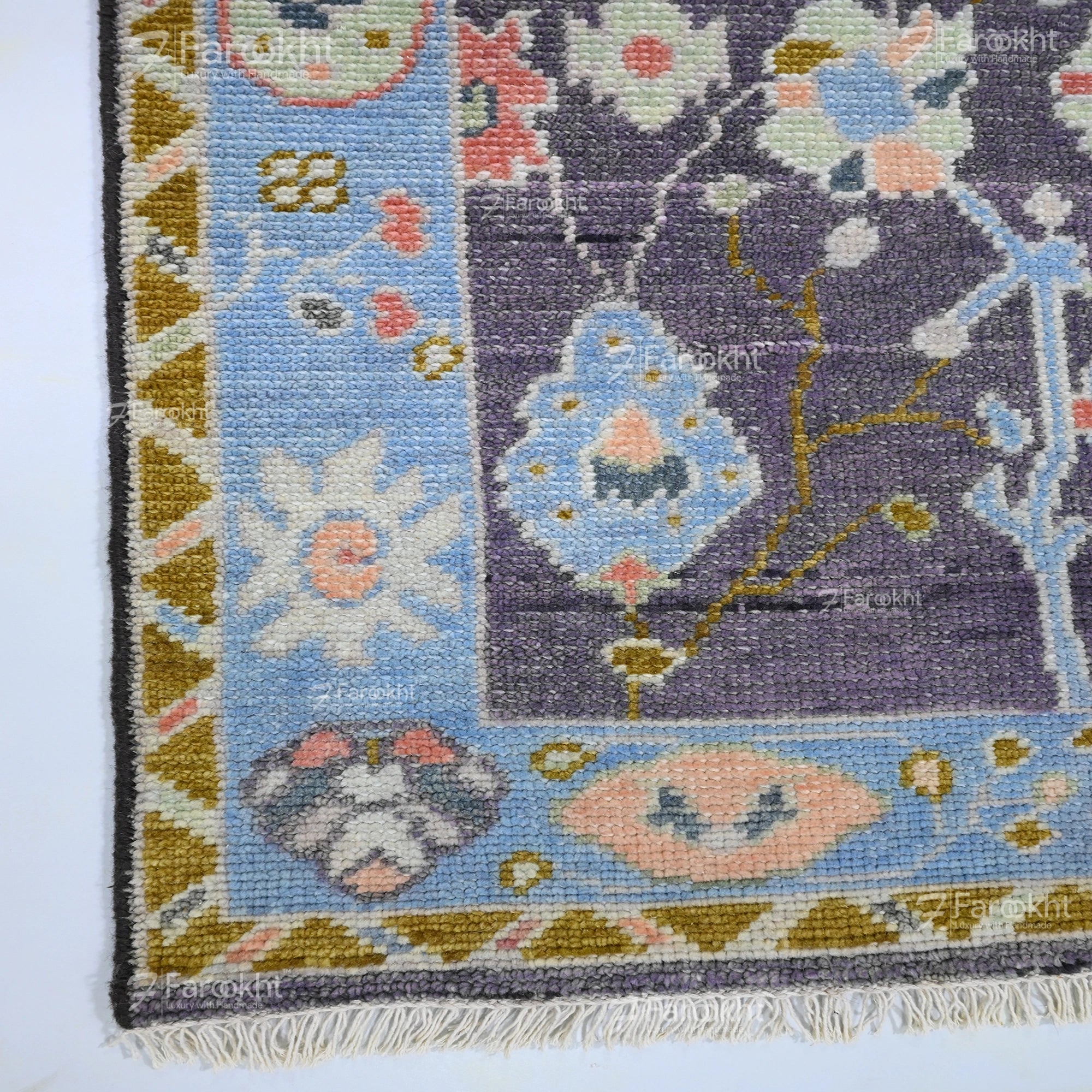 Elegant wool blend hand-knotted rug featuring blue border and intricate floral motifs