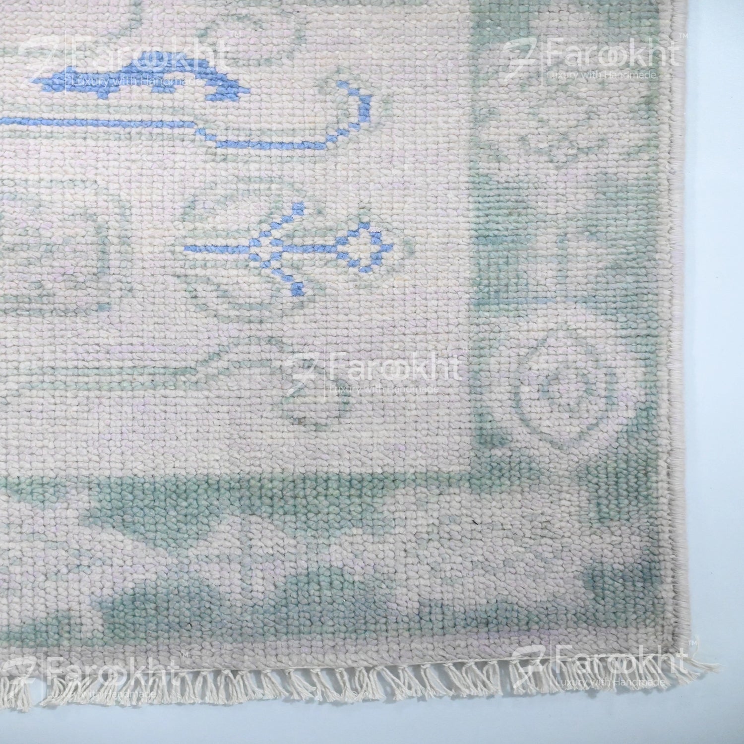 Textured fabric with embroidered patterns on a light blue background
