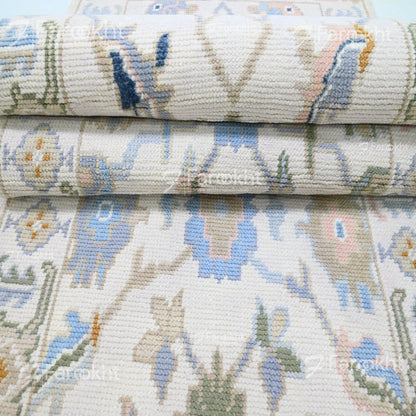 Close-up of a stack of patterned fabric rolls with floral designs.
