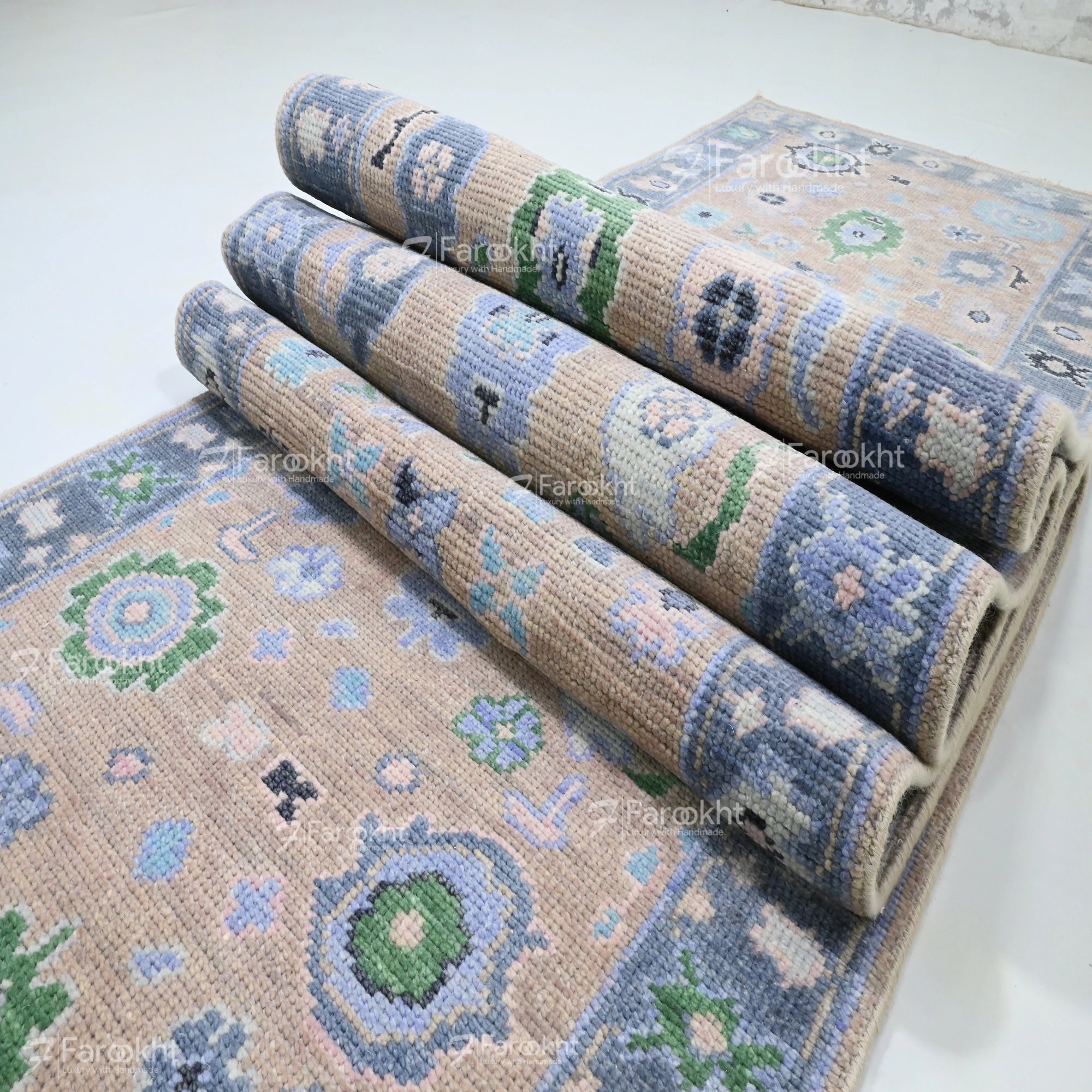Rolls of patterned rug on a white background