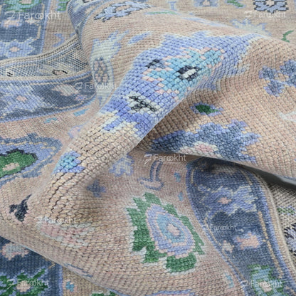 Close-up of a patterned rug with blue, green, and beige colors.