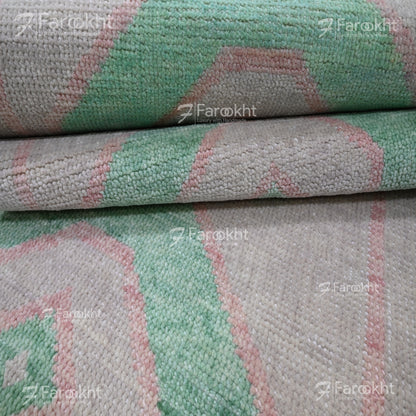 Stack of green and gray patterned fabric with &