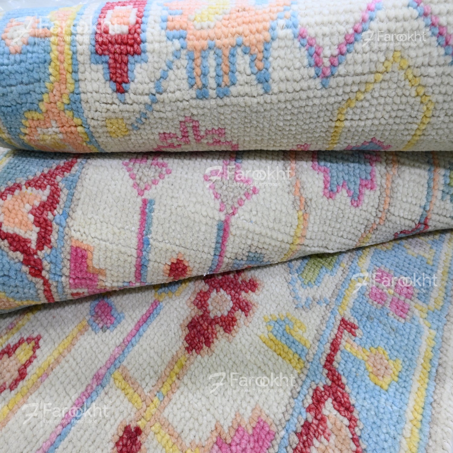 Close-up of a patterned fabric with colorful designs, featuring the brand &