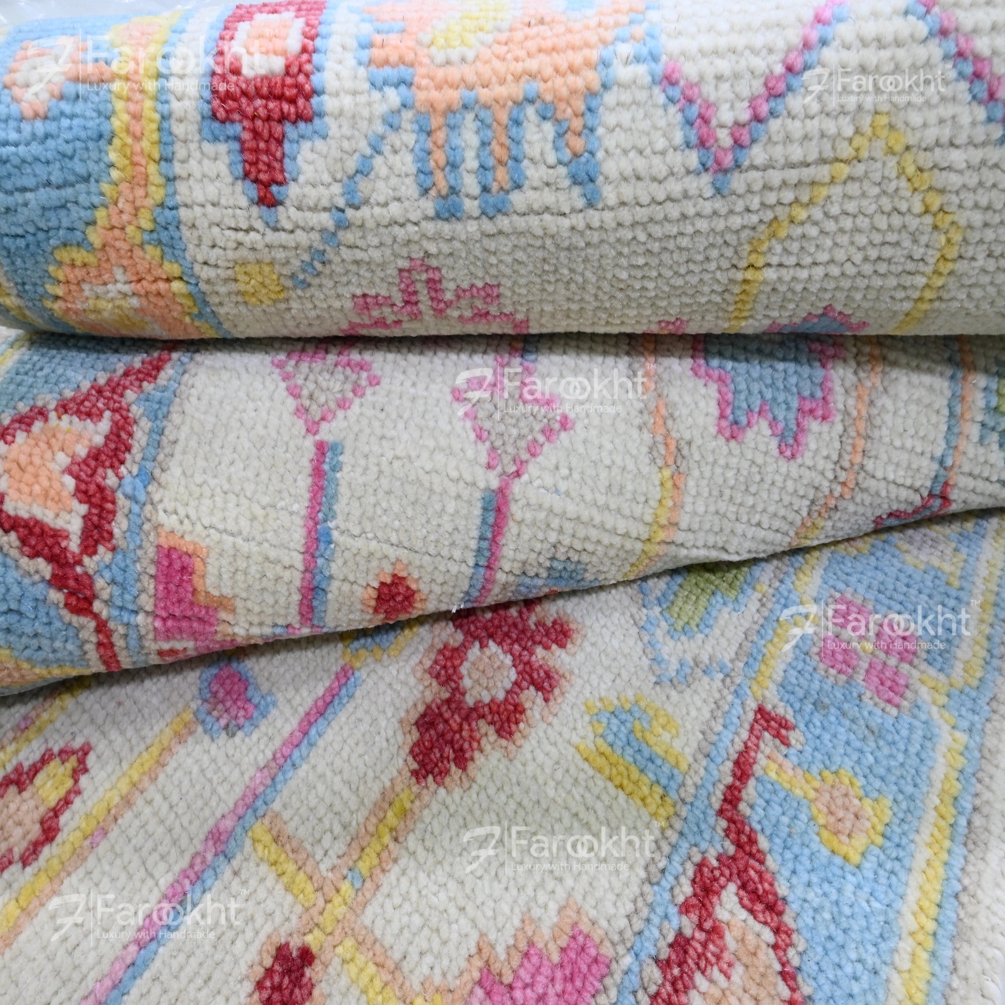 Close-up of a patterned fabric with colorful designs, featuring the brand &