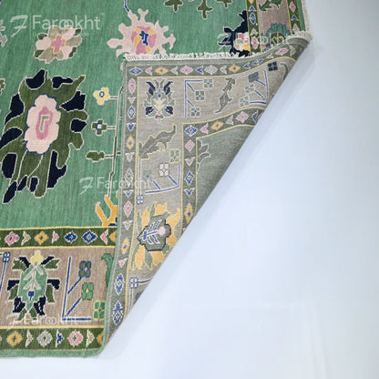 Close-up of a patterned rug with floral and geometric designs on a white background.