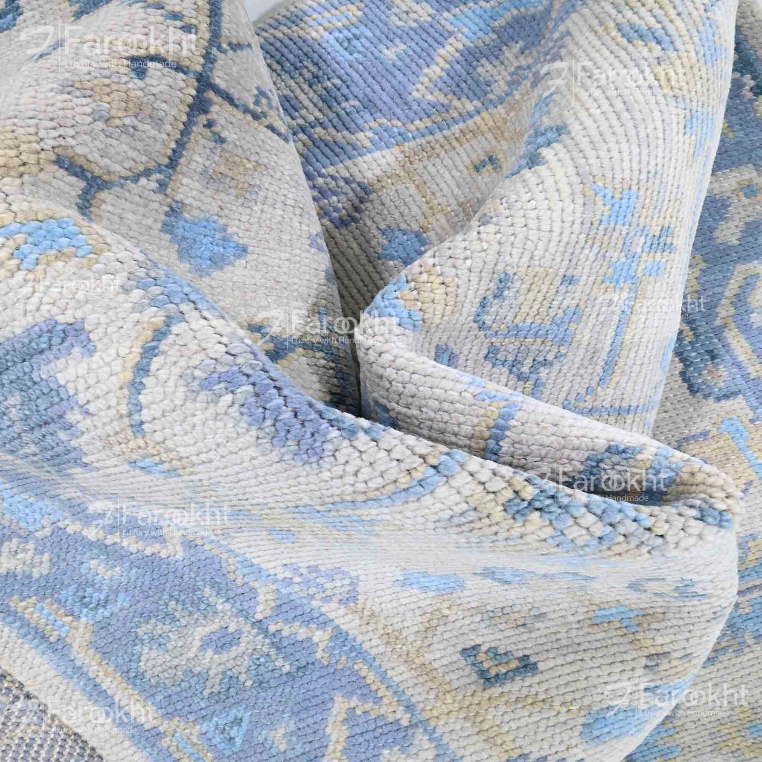 Close-up of a patterned blue and beige rug with &