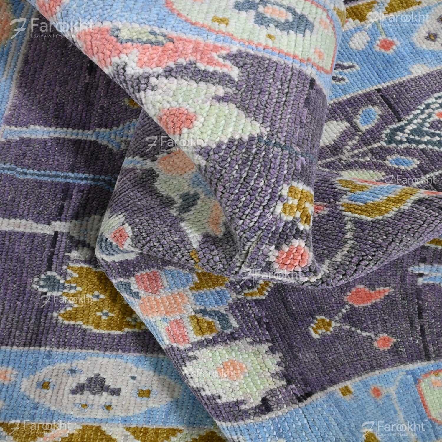 Close-up of a textured fabric with floral patterns in pastel colors.