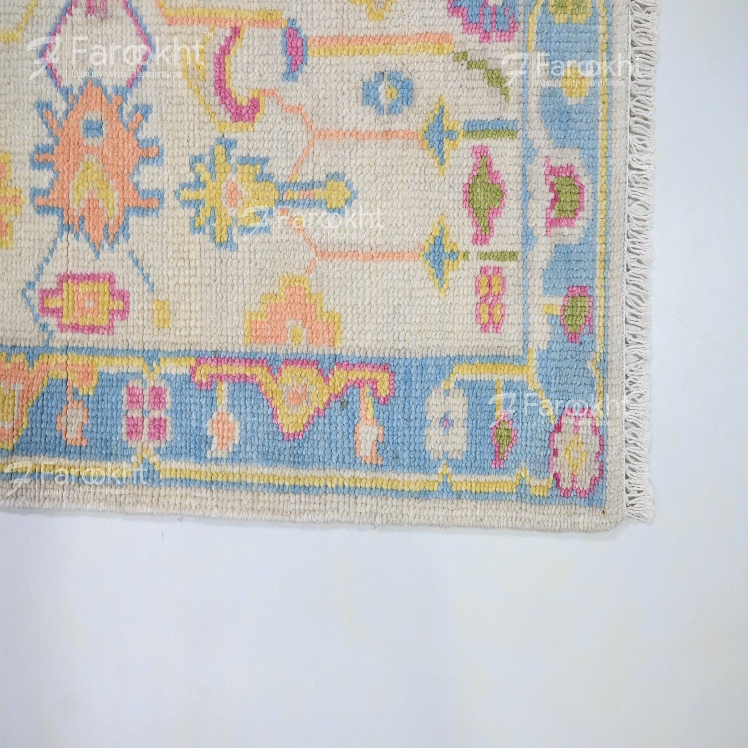 Artisan floral rug in lavender, coral, and peach tones