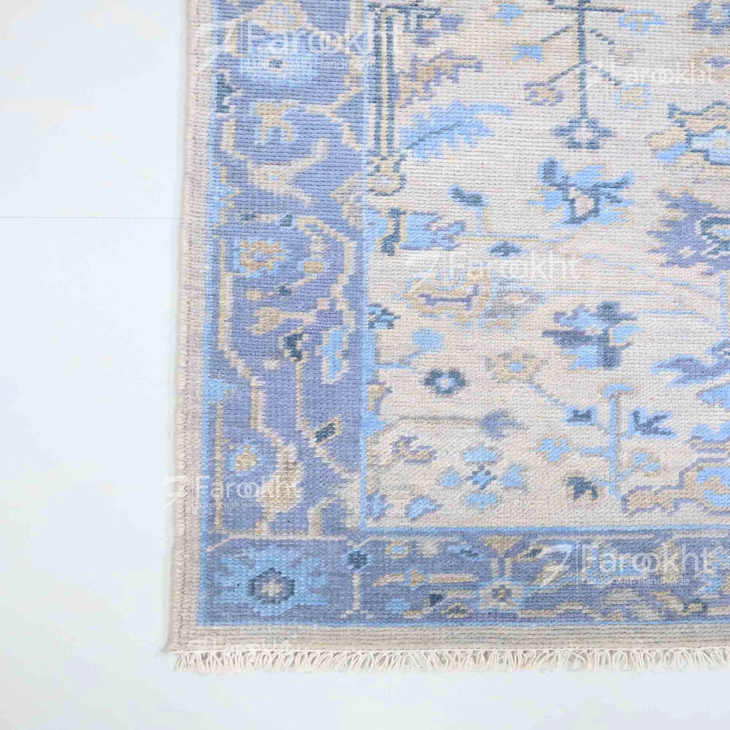 Blue and beige patterned rug on a white background