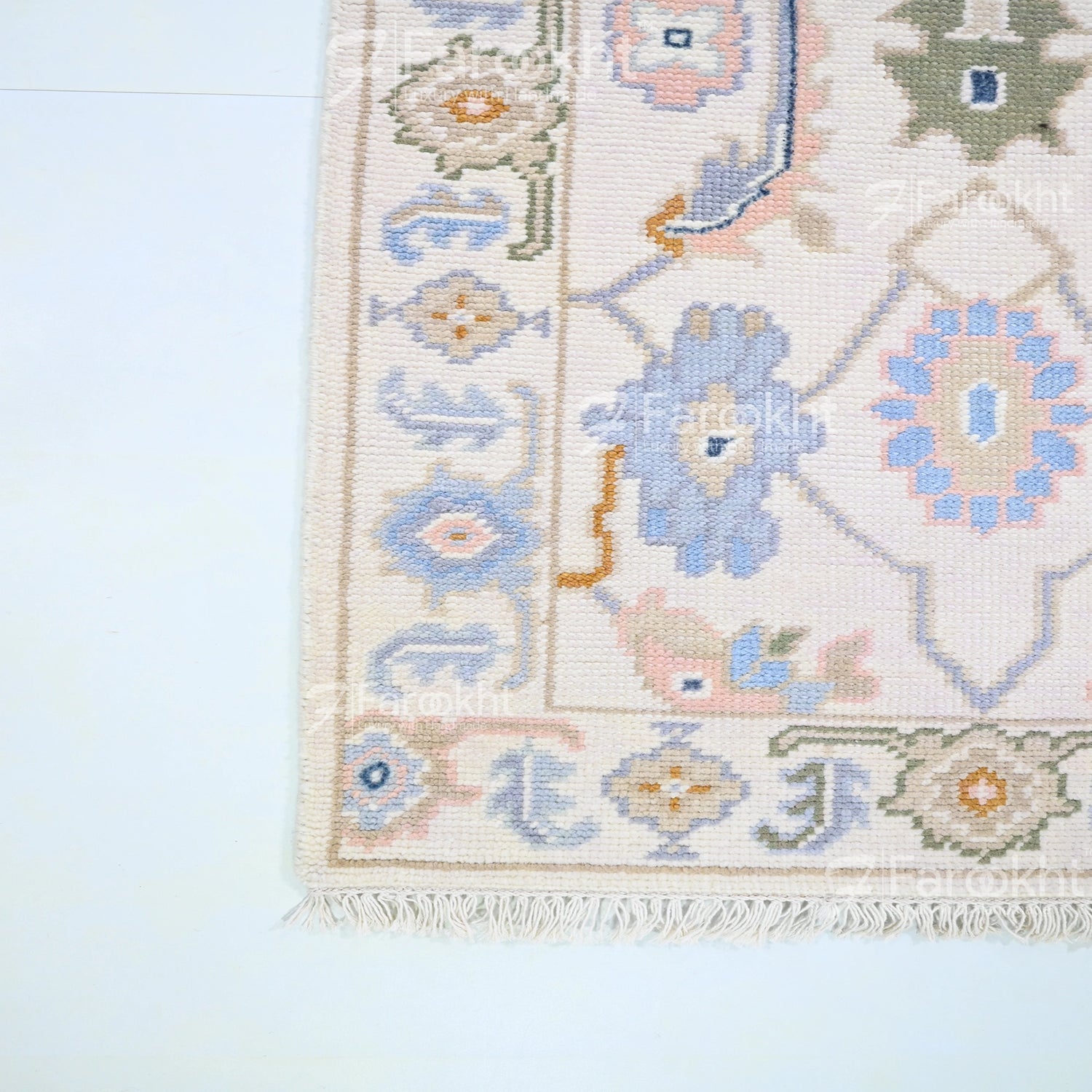 Close-up of a patterned rug with geometric designs on a light blue background