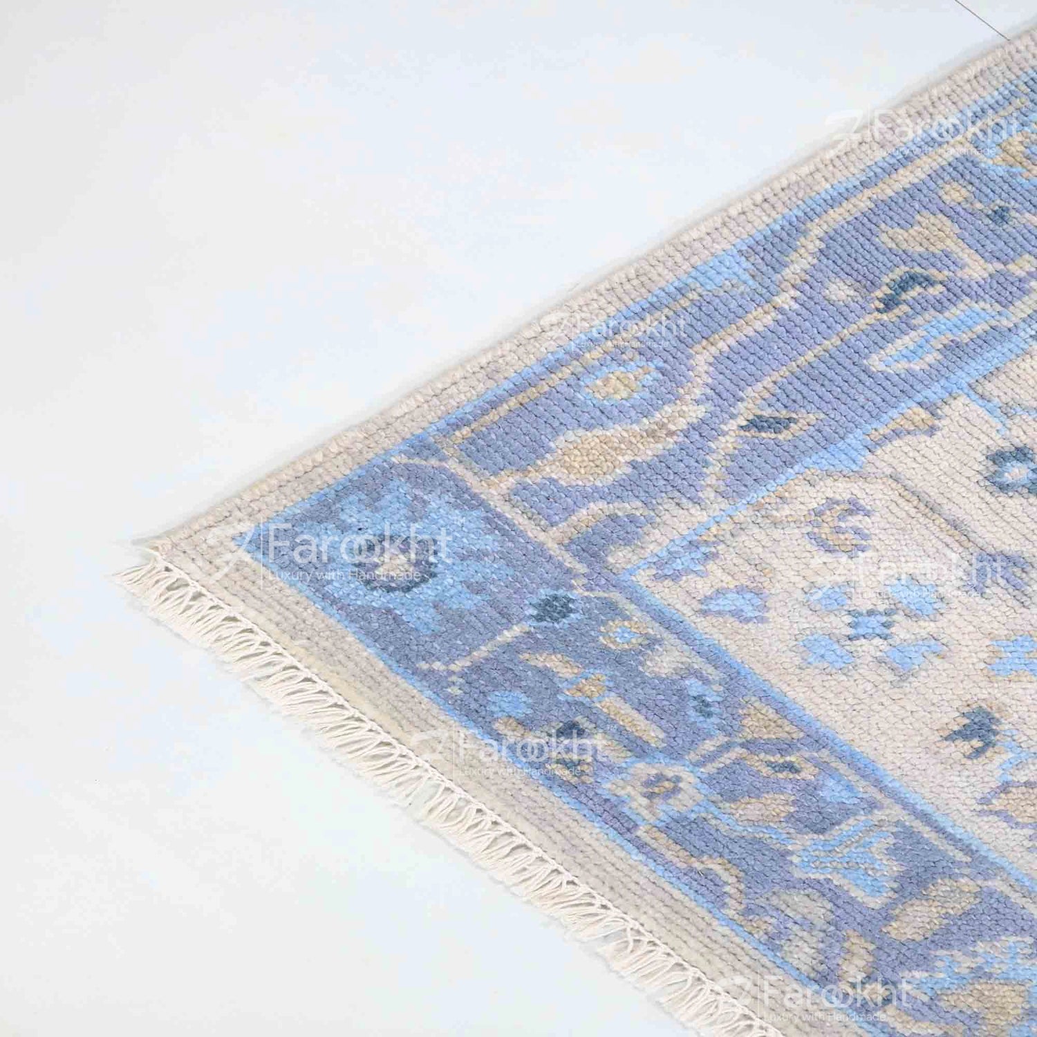 Blue and beige patterned rug on a white floor
