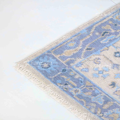 Blue and beige patterned rug on a white floor